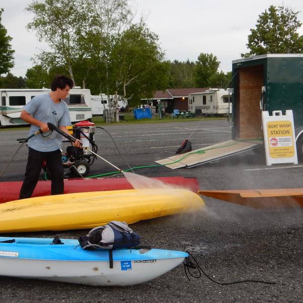 A public access greeter performs a watercraft decontamination.